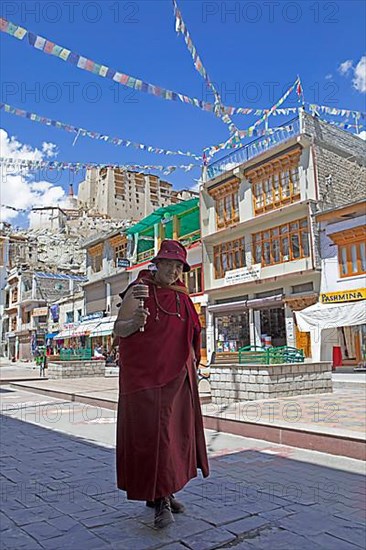 Ladakhi man with prayer wheel, Main Bazaar Road