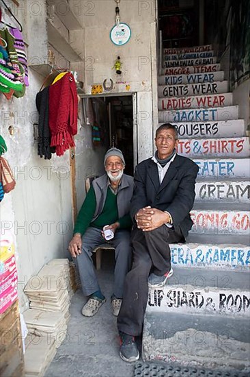 Ladakhi men on a staircase, Main Bazaar Road