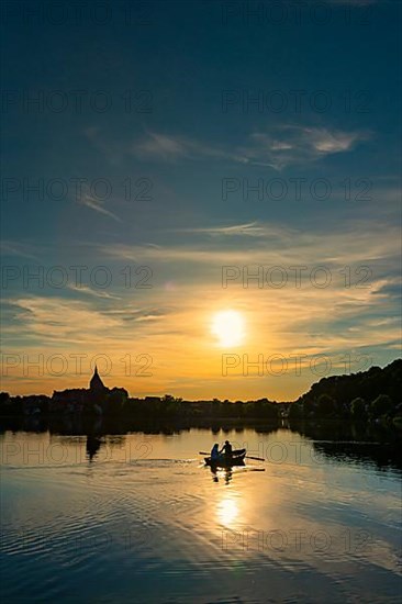 Rowing boat at sunset on the Ziegelsee, Moelln
