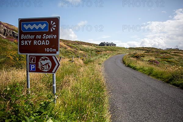 Road Sign in Irish and English on the famous Sky Road in Galway, Ireland