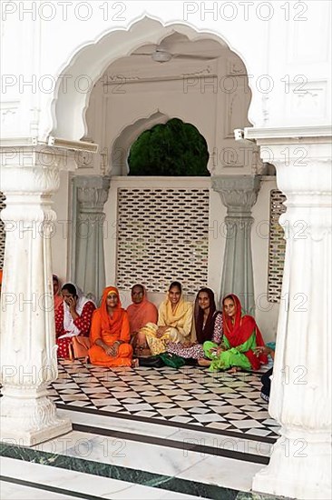 Indian woman in Indian robes and barefoot at the Hari Mandir or Golden Temple, Amritsar