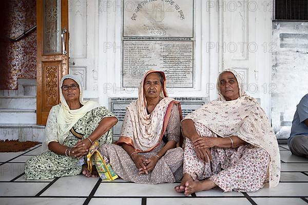 Indian woman in Indian robes and barefoot at the Hari Mandir or Golden Temple, Amritsar