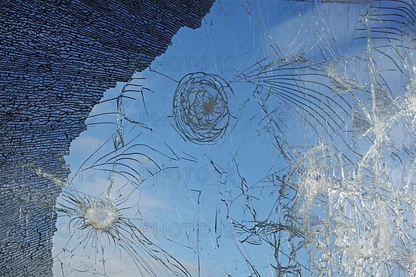Shattered and broken glass pane with fractures, cracks and shapes