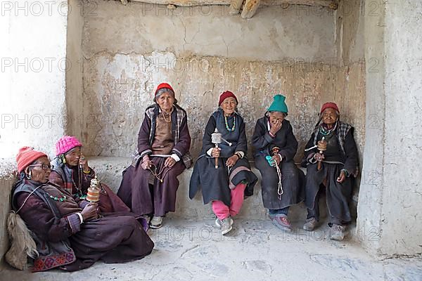 Old Ladkhi woman with prayer chain and prayer wheels, Lamayuru Monastery or Lamayuru Gompa