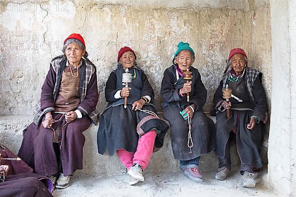 Old Ladkhi woman with prayer chain and prayer wheels, Lamayuru Monastery or Lamayuru Gompa