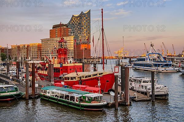 Museum lightship and launches in front of the Elbe Philharmonic Hall on the Elbe in Hamburg harbour in the evening sun, Hamburg