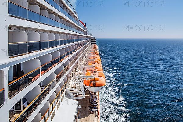 Transatlantic liner, Queen Mary 2 cruise ship on the high seas with boat deck and balcony cabins