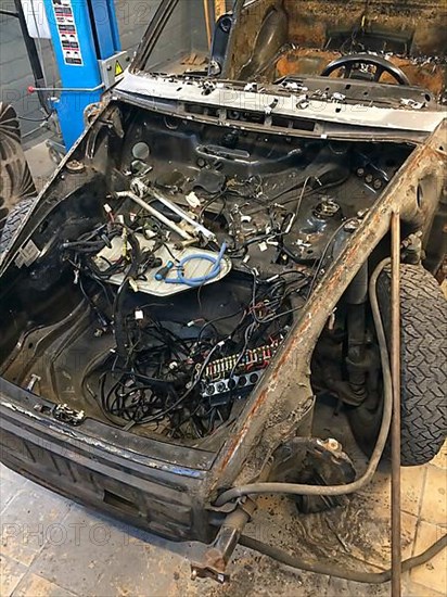 Gutted rusty body of historic classic sports car Classic Car Porsche 911 G model is prepared for restoration Reconstruction, Germany