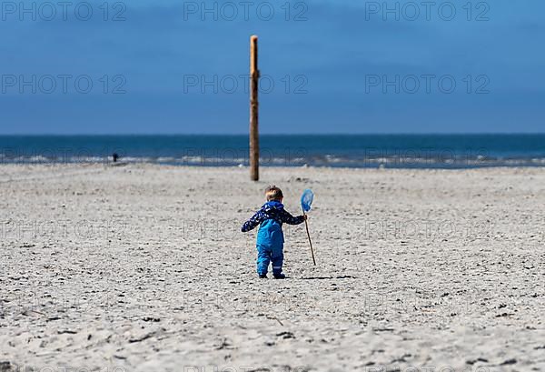 Toddler on the beach of the Baltic Sea, Sankt Peter Ording