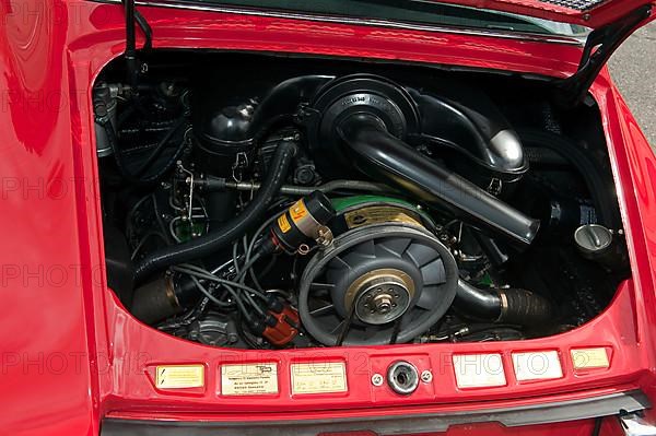 View into engine compartment with air-cooled boxer engine of classic vintage car Classic Car Porsche 911 E Targa from the 60s, Techno Classica fair