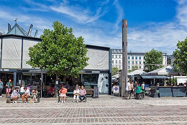 Visitors in front of the Torvehallerne market hall with street food and specialities, Norrebro district