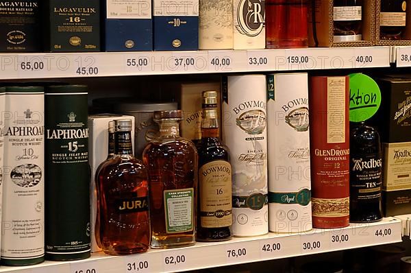 Various whisky bottles on the sales shelf in a supermarket,