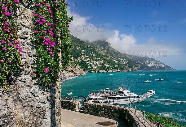 Promenade by the sea with excursion boat, Positano