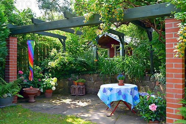 Pergola with garden shed and table