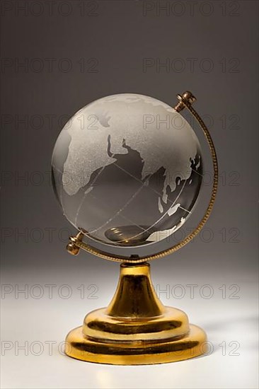 Crystal glass globe on gradient gray background