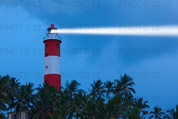 Lighthouse in night with light beam