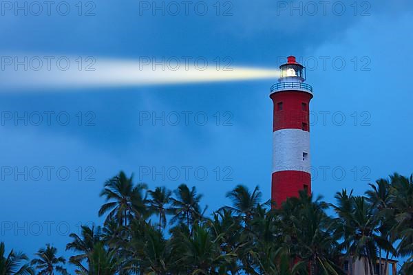 Lighthouse in night with light beam