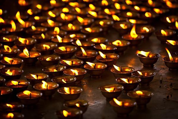 Burning candles in Buddhist temple. Tsuglagkhang complex