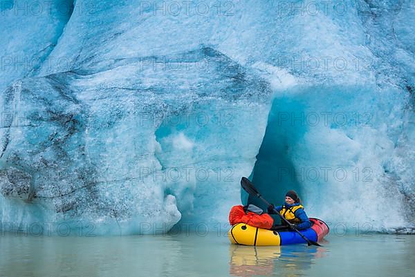 Woman with packraft at sea