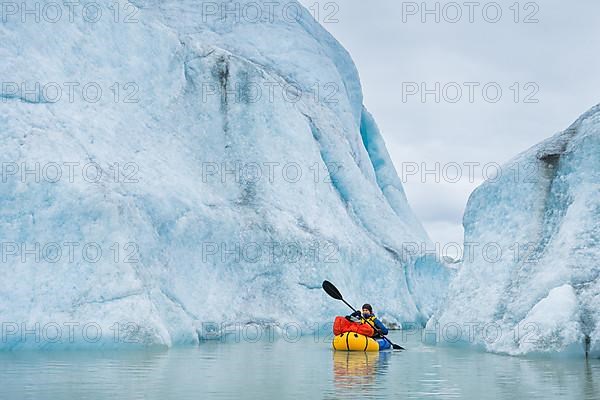 Woman with packraft at sea