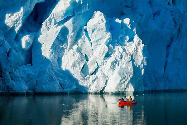 Man with packraft on fjord