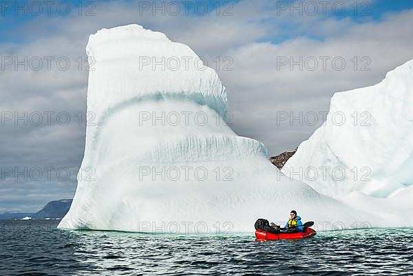 Man with packraft on fjord