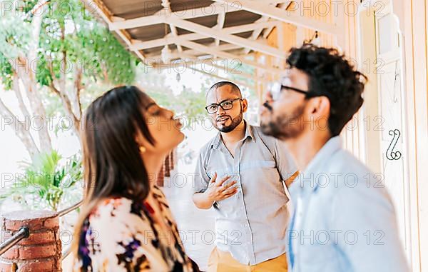 Man looking at his cheating girlfriend kissing another woman outdoors