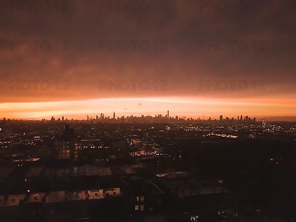 Aerial View from Brooklyn over far away Manhattan Skyline in the Distance after Sunset with Fire Red Light and Skyscraper Silhouette HQ