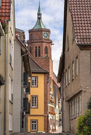 Tunnel view of the church through an alley of half-timbered houses