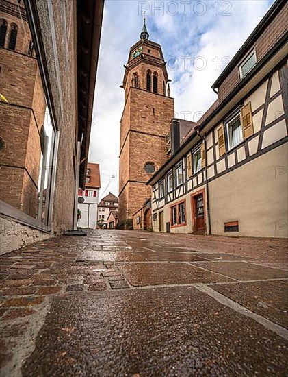Tunnel view of the church through an alley of half-timbered houses