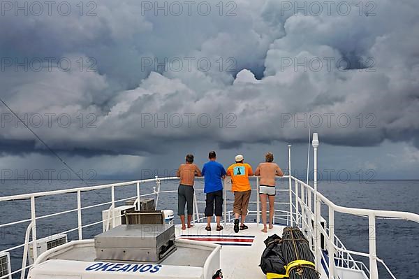 The Okeanoss Aggressor. Liveaboard with tourists and Gewtiter clouds