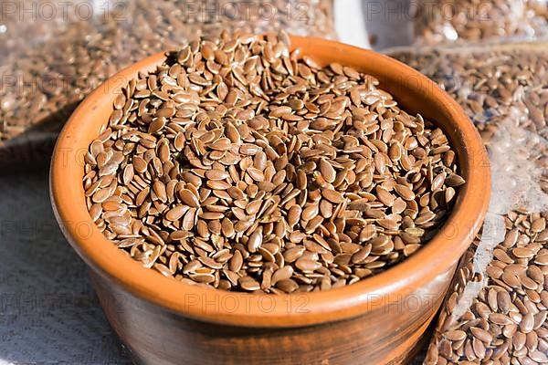 Flax seeds in a clay bowl close-up