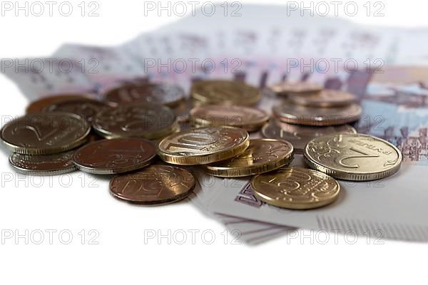 Rubles coins against background of 500 rubles banknotes fan close up