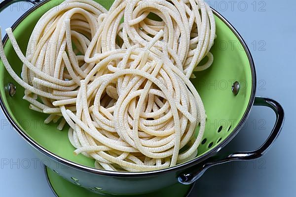 Pici pasta in kitchen colander