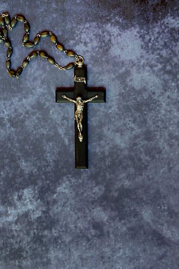 Crucifix and rosary on a dark background