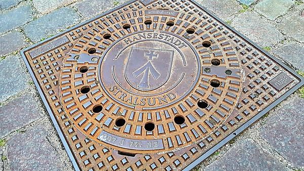 Manhole cover with coat of arms of the Hanseatic City of Stralsund. Mecklenburg-Western Pomerania