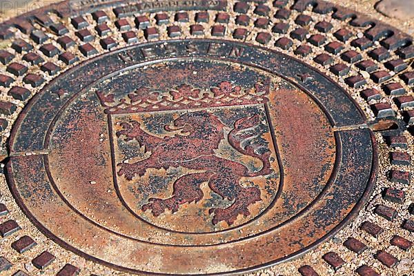 Manhole cover with the coat of arms of Seligenstadt. Seligenstadt
