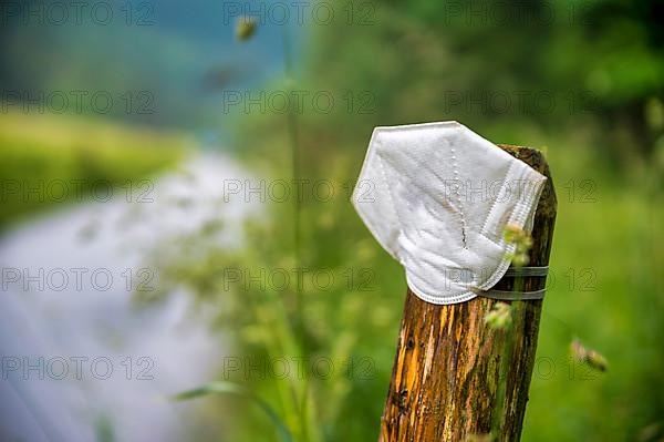 FFP2 mask on the post of a pasture fence