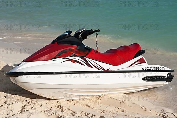 Jet ski on beach sand near sea