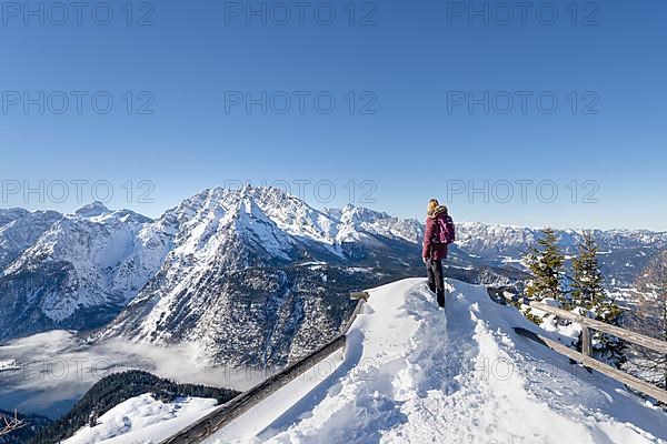 Woman standing at the top of the mountain Jenner looking into the snowy winter landscape