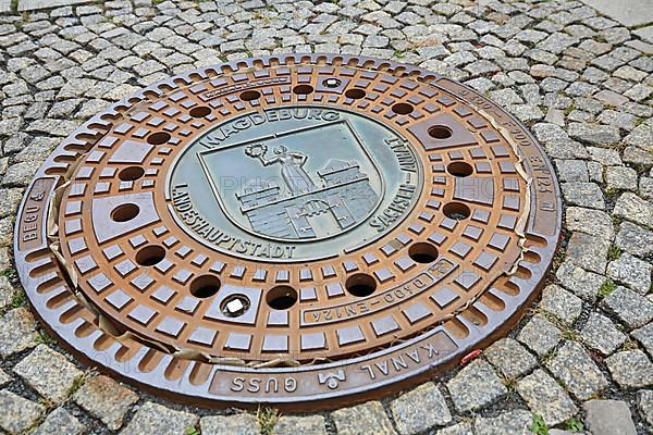 Manhole cover of Magdeburg with coat of arms of the city