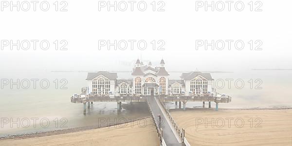 Sellin pier on the Baltic Sea island of Ruegen at fog