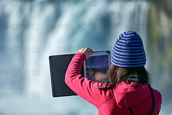 Young woman making panorama with tablet