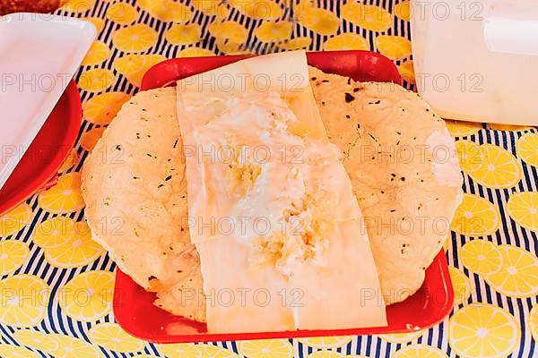 Traditional Nicaraguan Quesillo served on a plate on the table. Top view of Nicaraguan Quesillo served on table. Latin American food Quesillo