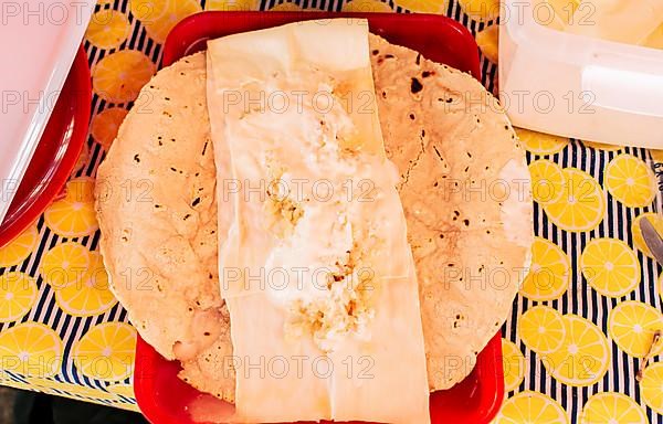 Top view of Nicaraguan Quesillo served on table. Traditional Nicaraguan Quesillo served on a plate on the table. Latin American food Quesillo