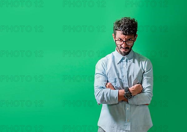 Angry and annoyed man with crossed arms isolated