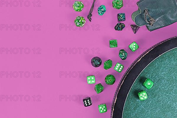 Different green roleplaying dices on purple background