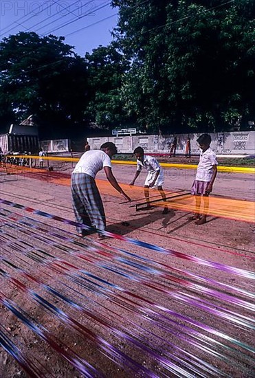 Colorful cotton sungudi saris under operation at Madurai