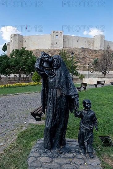 Statue of an Anatolian woman with children in front of Gaziantep Castle