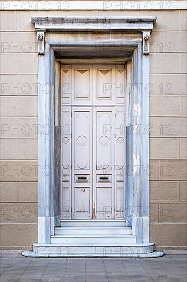 Closed old white wooden house door